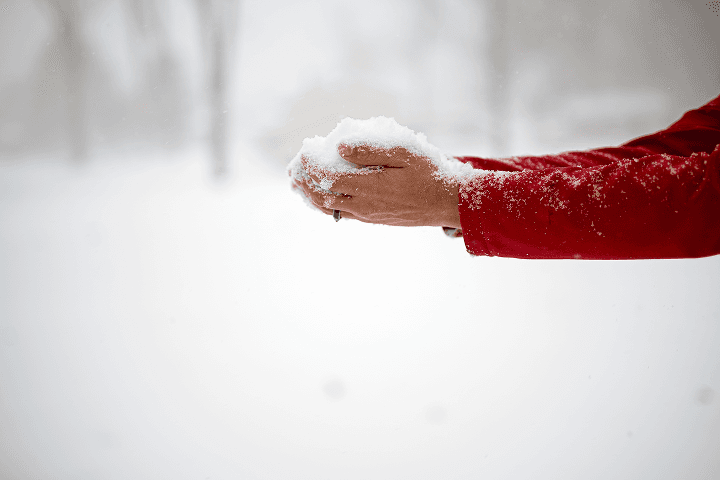Hand holding real snow